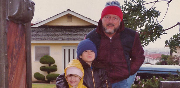 Charles Slater in his fifties posing outside his Silver Street home with his son and daughter who are elementary school age at the time.